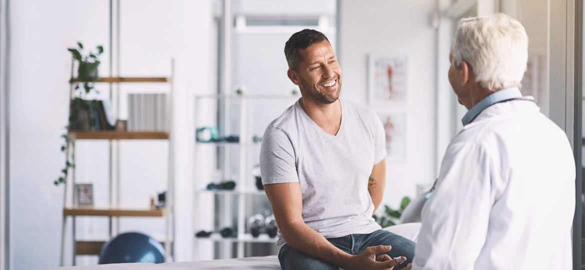 man talking to doctor about hair transplant