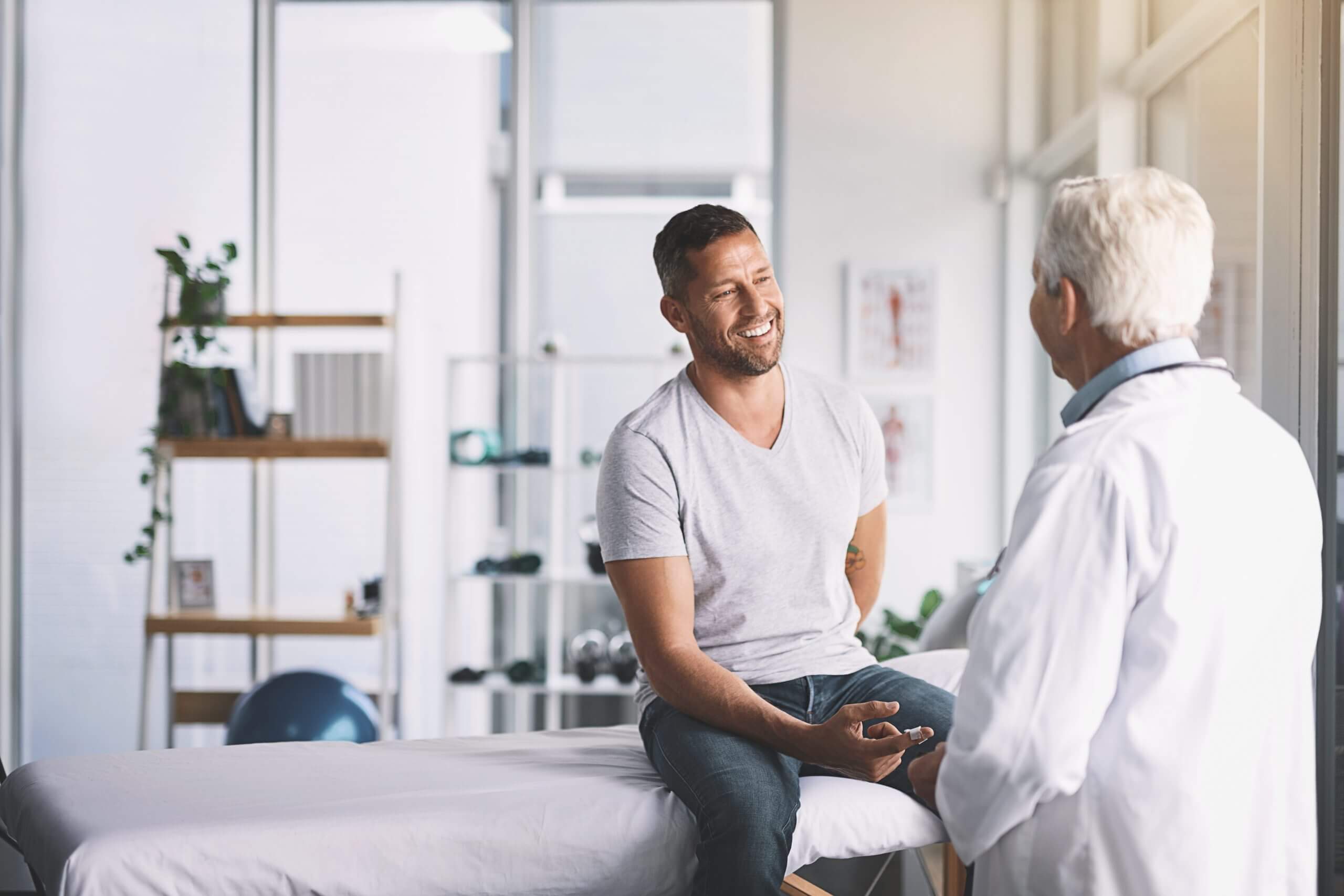 man talking to doctor about hair transplant