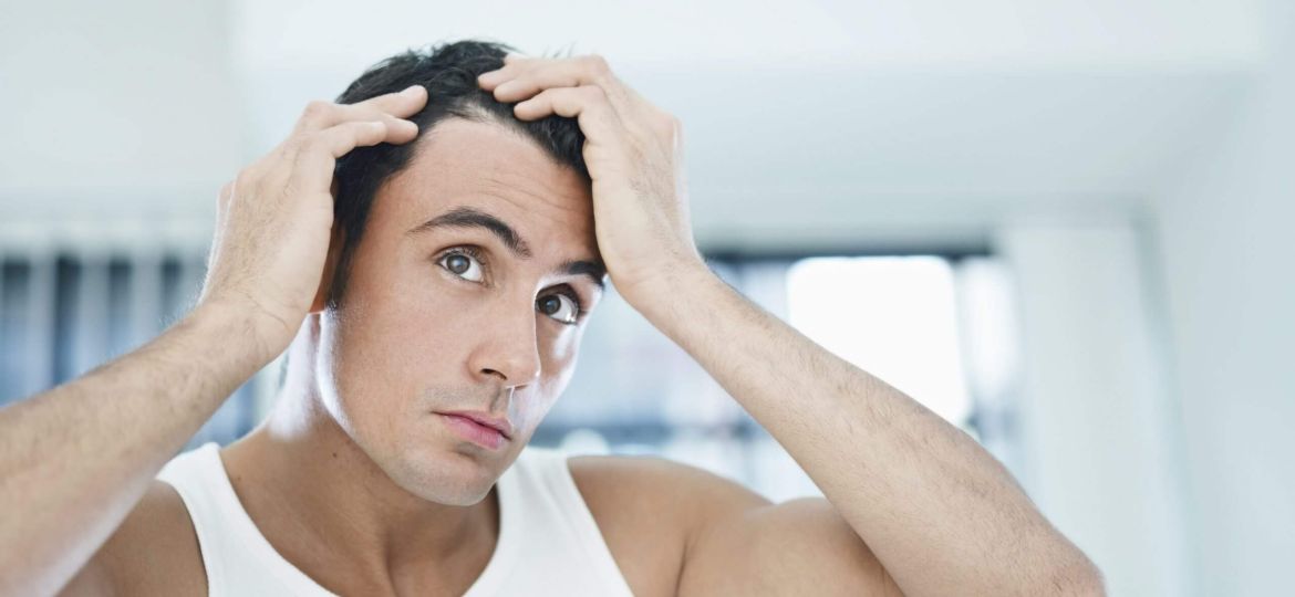Man running fingers through hair
