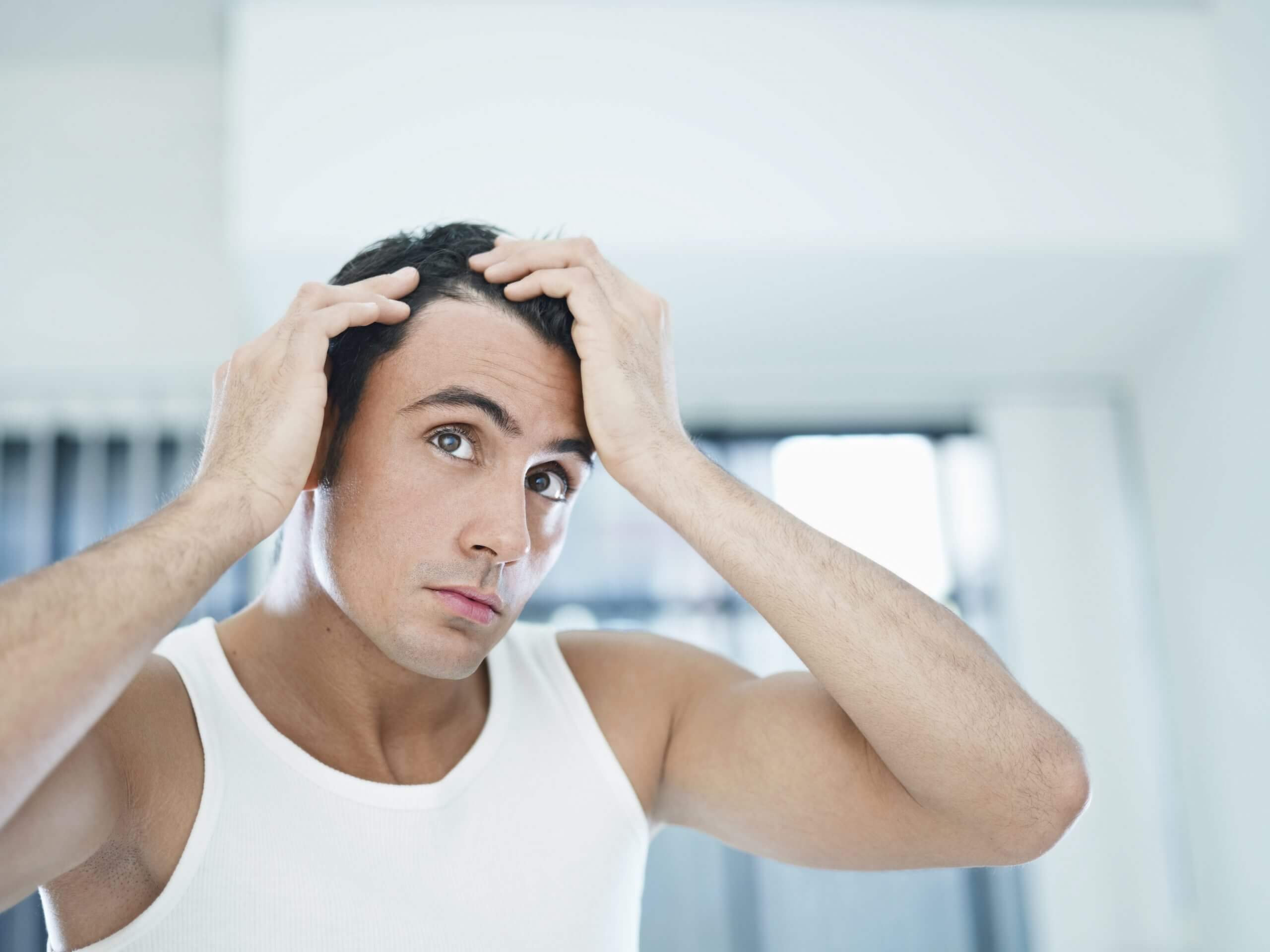 Man running fingers through hair