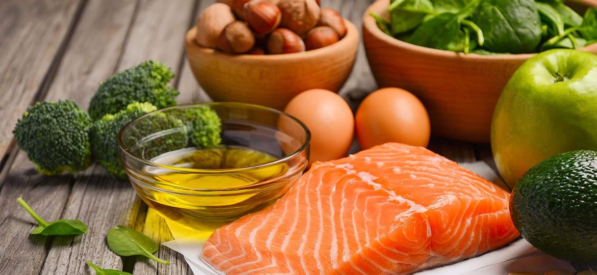 salmon, eggs, nuts, and greens sitting on a table