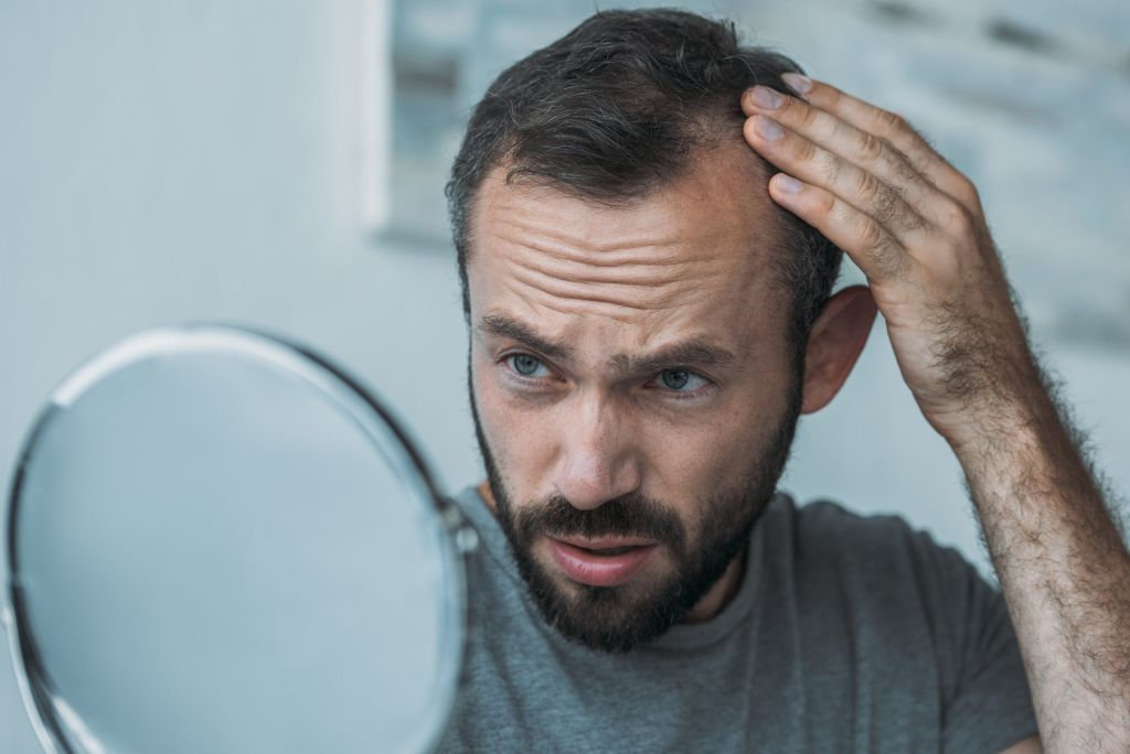 man noticing he's losing hair