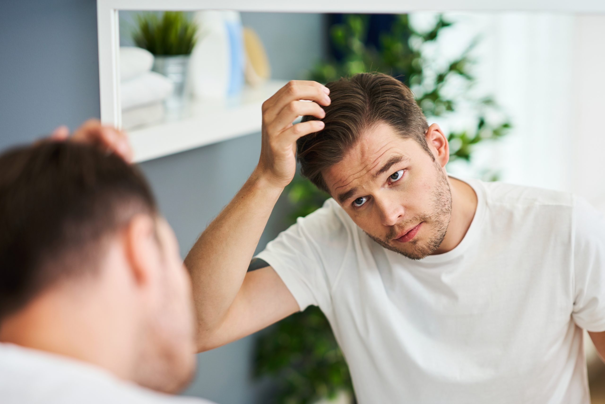 man checking for hair loss