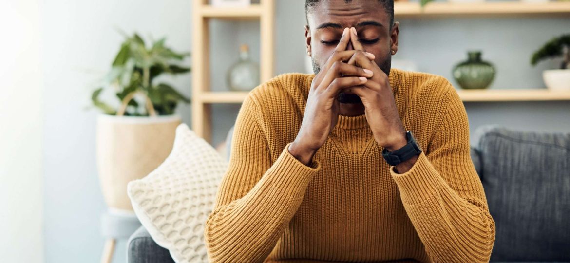 man looking worried with hands over face