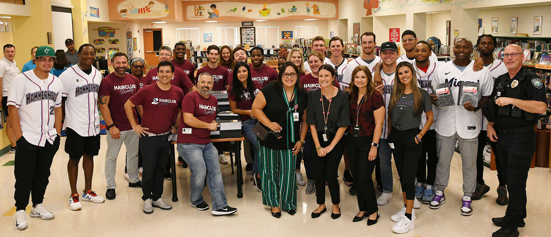 hairclub-employees-miami-marlins-team-up-to-donate-back-to-school-supplies-to-students