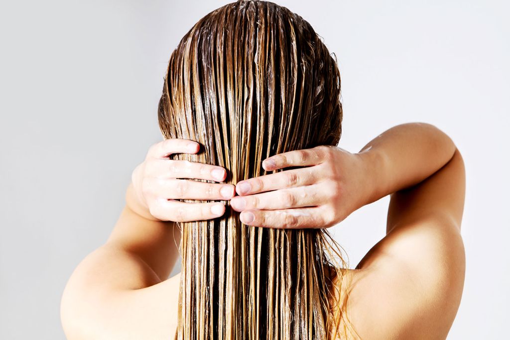 Woman washing her hair in hard water