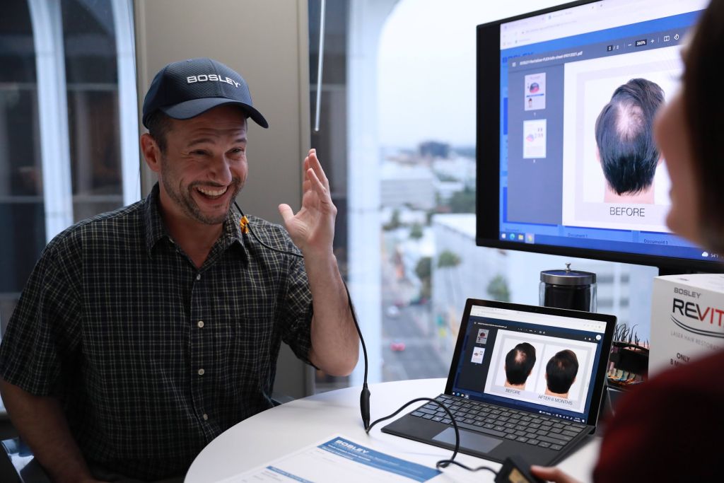 Hair Loss Treatments Compared during a Bosley consultation, showing before-and-after hair restoration results on a screen with a specialist explaining treatment options to a patient