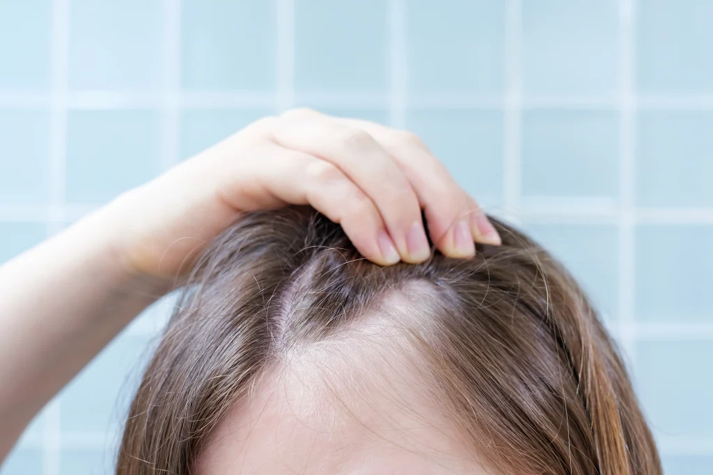 woman-touching-her-hair-close-up-against-background